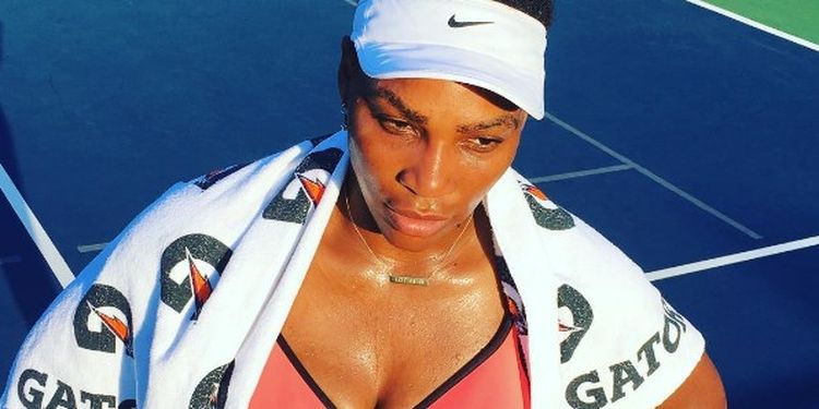 Workout addict Serena Williams with a towel after the training