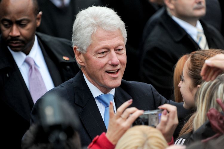 Photo of Bill Clinton smiling in a front of people