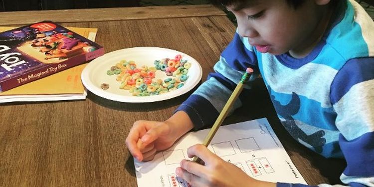 image of a boy drawing with his left hand