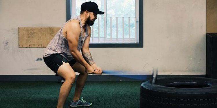 Image of a man doing a sledgehammer workout