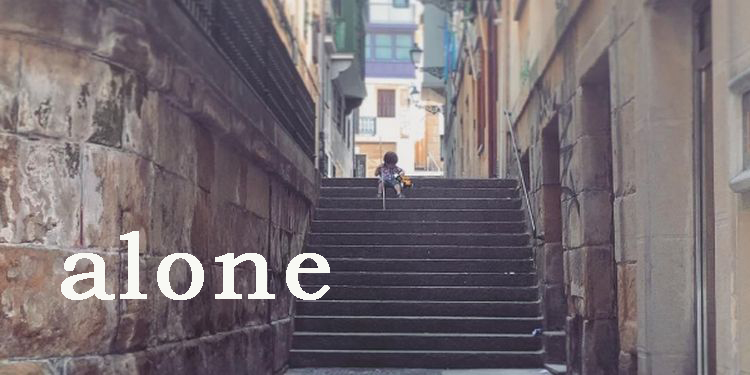 Image of a lonely kid sitting on the stairway