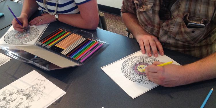 Photo of people coloring the coloring books