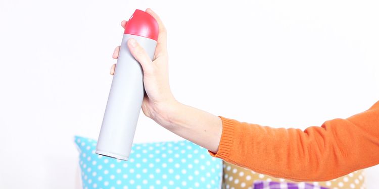 Photo of a woman using air freshener