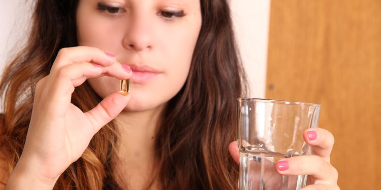 Photo of a woman taking the pill 