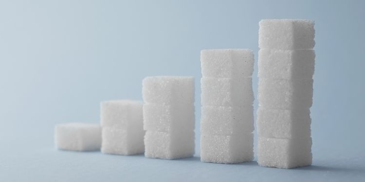 Photo of ascending stack of sugar cubes