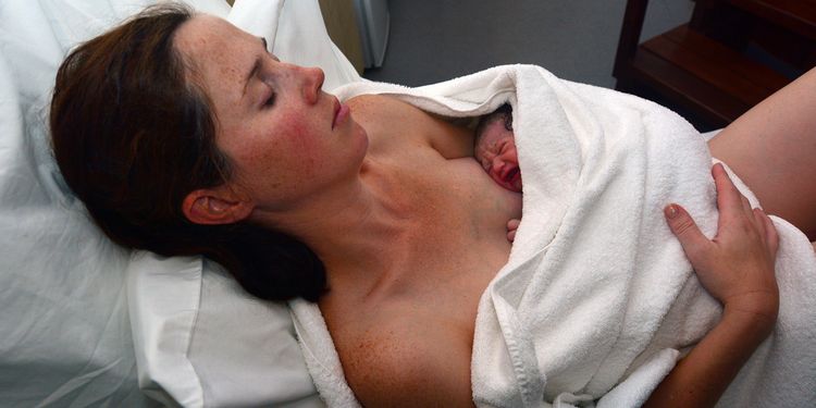 Photo of a baby with mother at childbirth