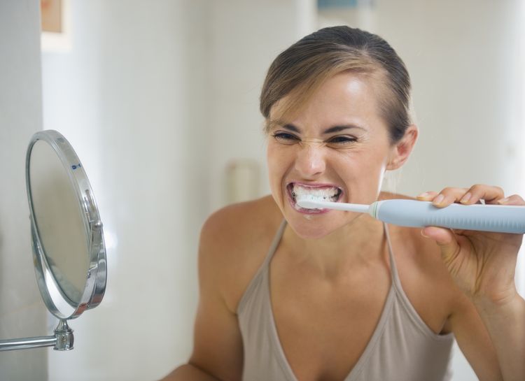 Photo of a woman Brushing Teeth with Coconut Oil