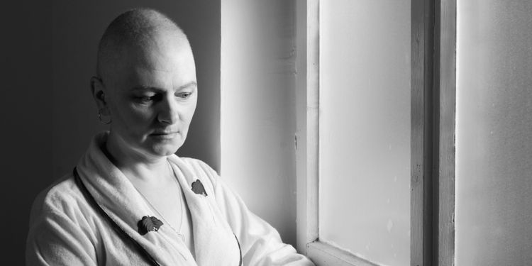 Photo of cancer patient next to a window