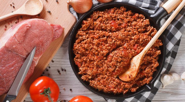 Photo of chilli Bolognese sauce in a pan on table