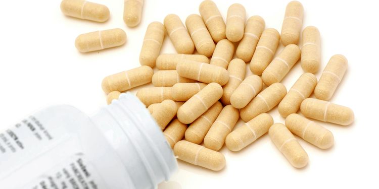 Photo of opened bottle with digestive enzymes pills