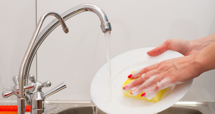 Photo of a person washing dishes