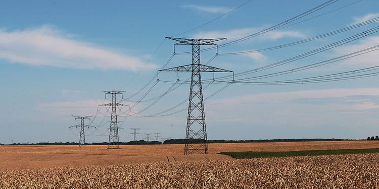 Photo of high voltage electrical power lines in crop field