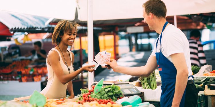 Photo of woman buying organic foods at marketplace