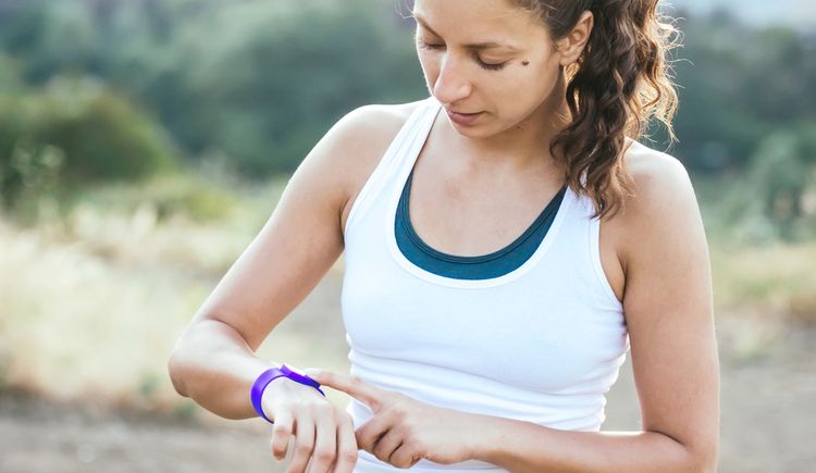 Photo of woman looking at fitness tracker