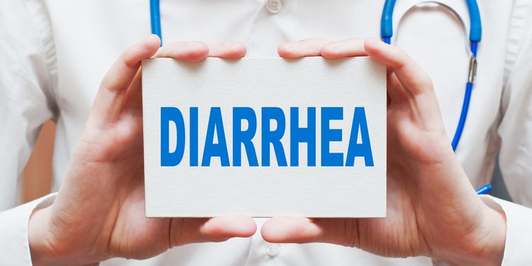 Photo of a doctor holding card saying DIARRHEA