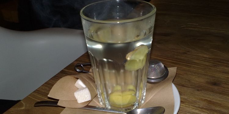 Photo of glass with ginger tea 