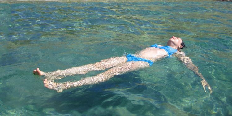 Photo of girl floating backside in water relaxed