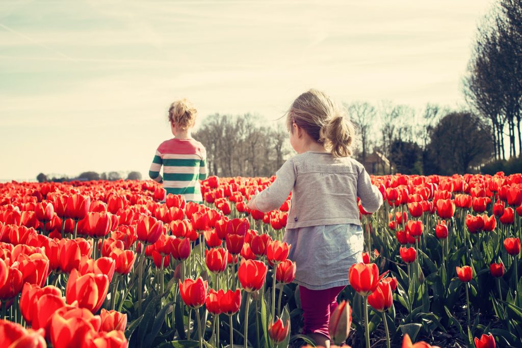 girls walking through garden