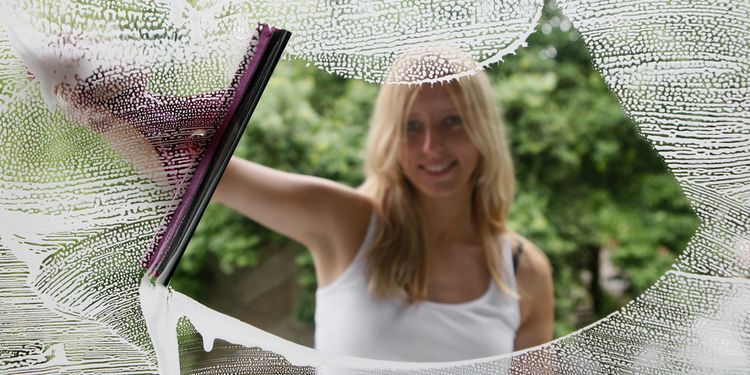 Photo of a girl cleaning window