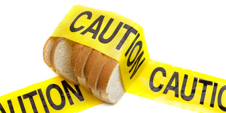 Photo of a white bread slices in yellow tape saying CAUTION