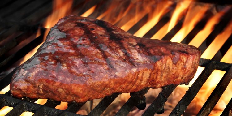 Photo of beef steak on a grill