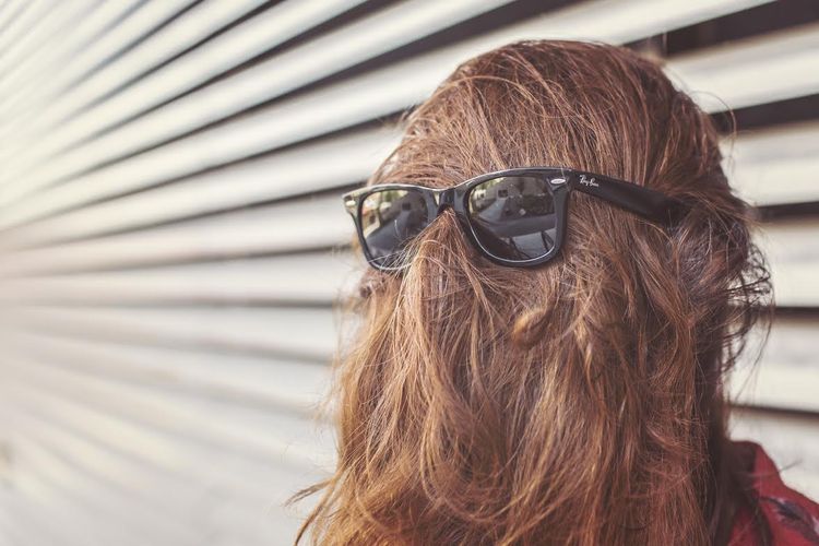 Photo of a woman wearing singlasses backwards