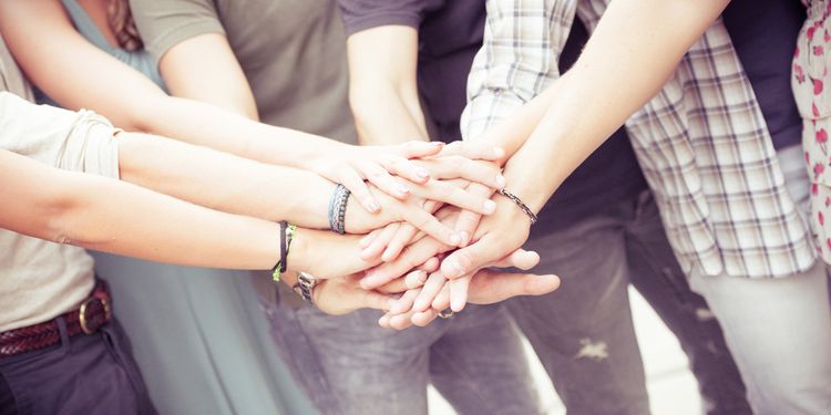 Photo of people holding hands