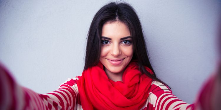 Photo of a young woman staring at the camera smiling