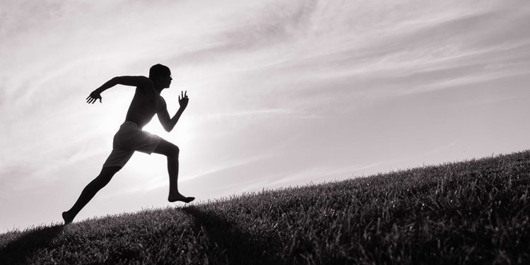 Photo of man running uphill