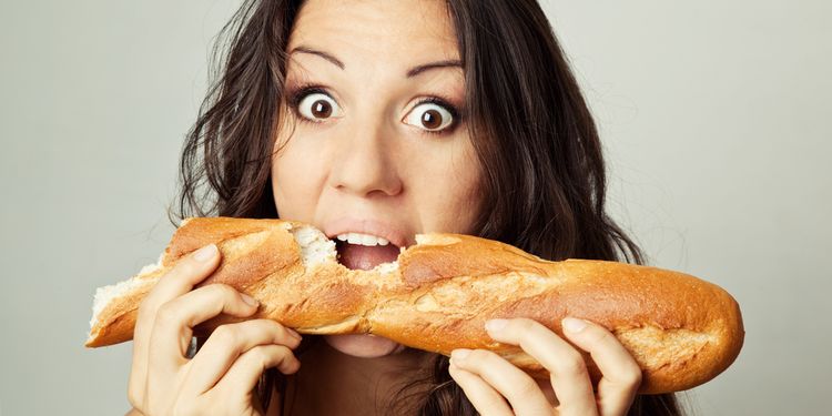 Photo of a woman eating french bread