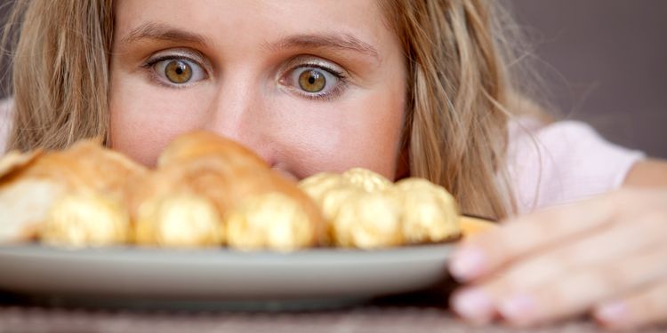 Photo of woman looking at the croissants with Hungry Eyes