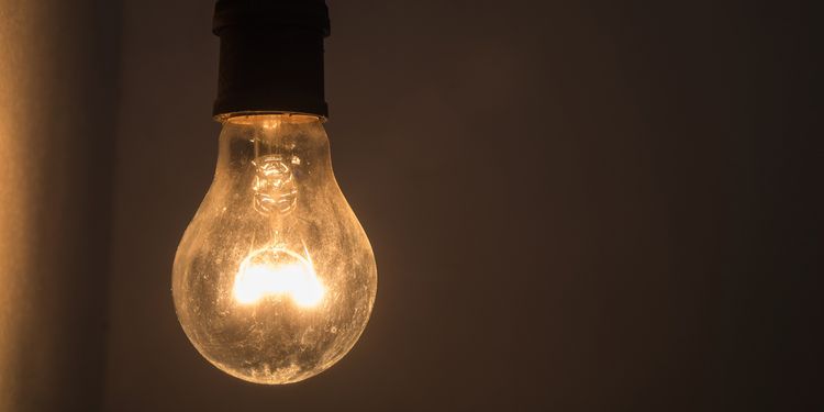 Incandescent light bulb in dark room