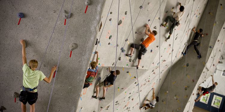 Photoof people climbing on indoor climbing wal