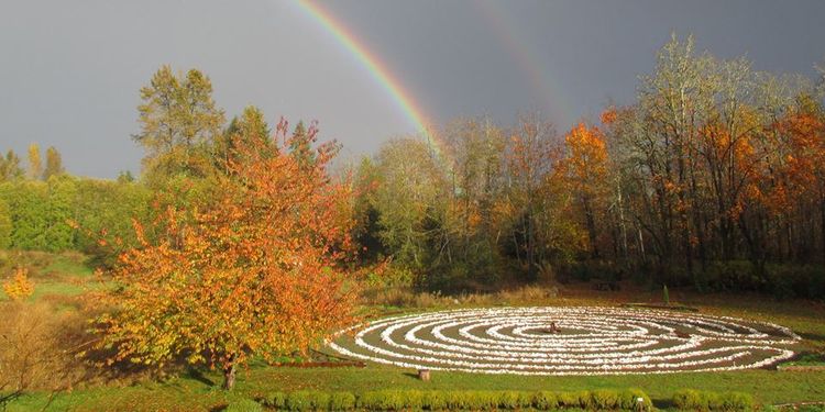 Photo of Innisfree Farm shell labyrinth with rainbow in background