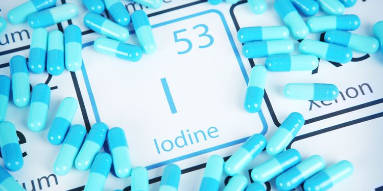 Photo of iodine symbol surrounded by spilled pills