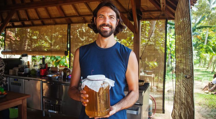 Man holding a jar of Kombucha Tea