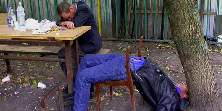 Photo of two drunk men sleeping outdoors