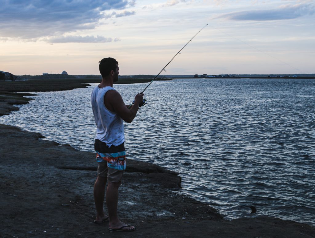 man fishing on shore