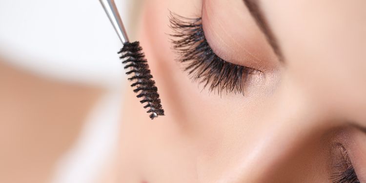 Photo of a woman using mascara