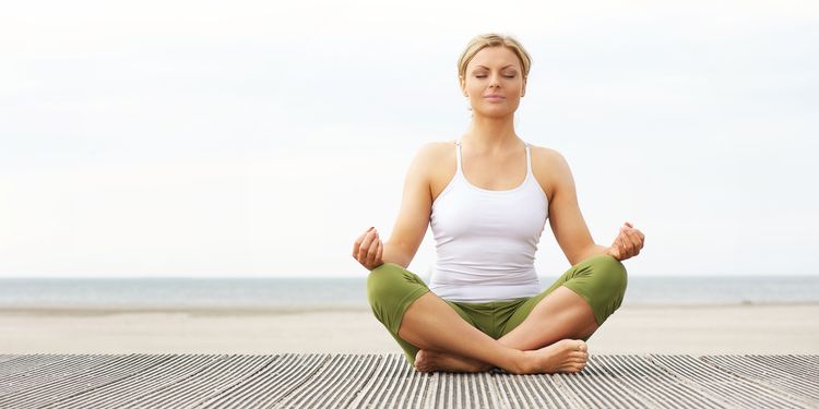 Photo of calm woman meditation outdoors