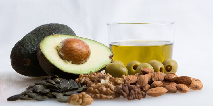 Photo of Healthy Food With Avocado, Nut, Olive Oil And Olive on white background