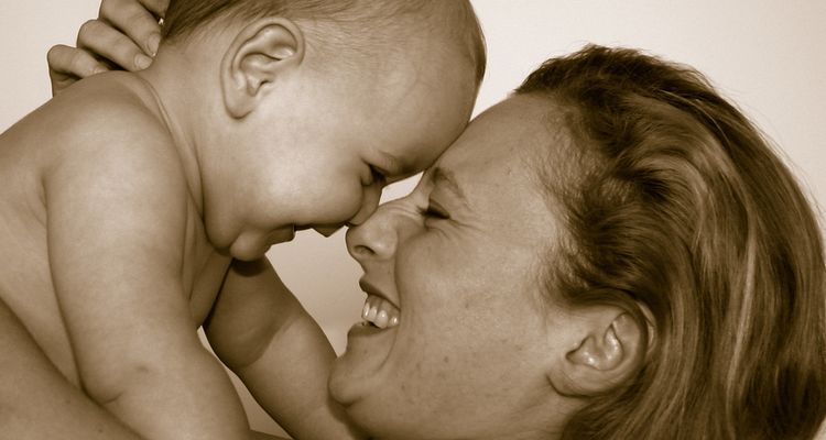 Photo of mother with her baby smiling