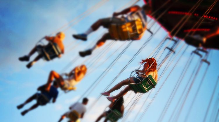 Photo of people spinning on a wheel in lunapark