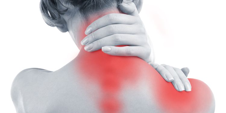 Photo of a woman holding her inflamed neck muscles