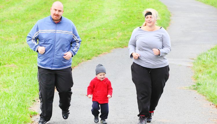 Photo of overweight parents with small child