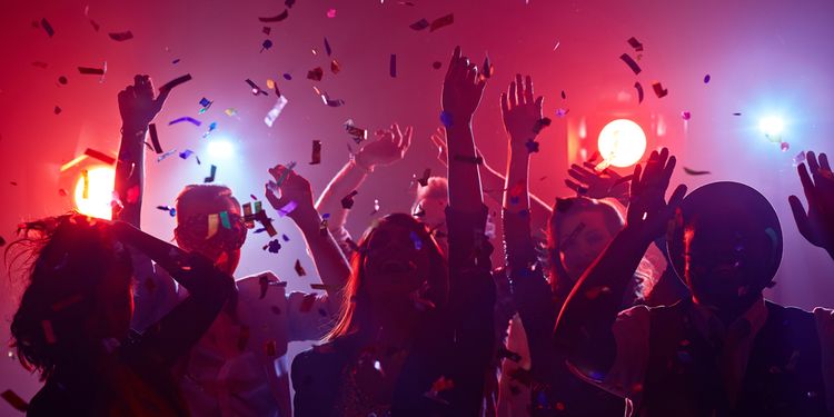 Photo of Young people dancing in night club