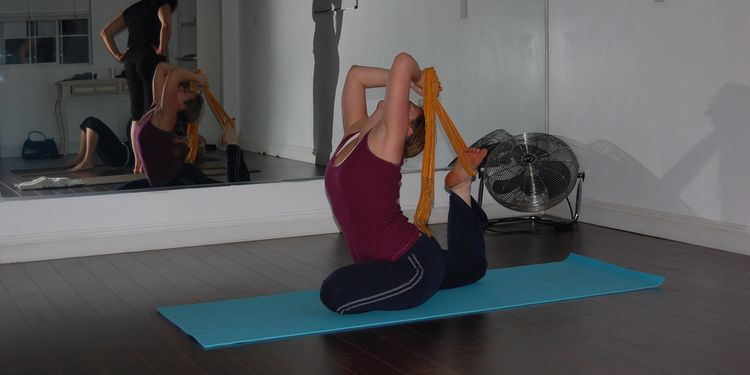 Photo of a woman performing pidgeon yoga pose