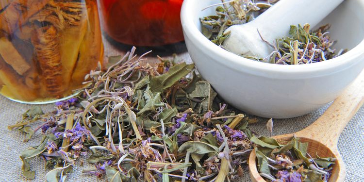 Photo of dry herbal tea Chamerion is with tinctures in bottles on sackcloth, herbal medicine