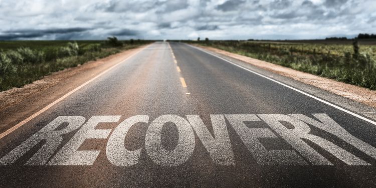 Photo of a highway road with RECOVERY written on it