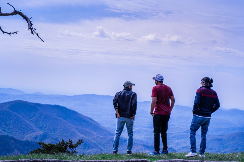 people standing on hill